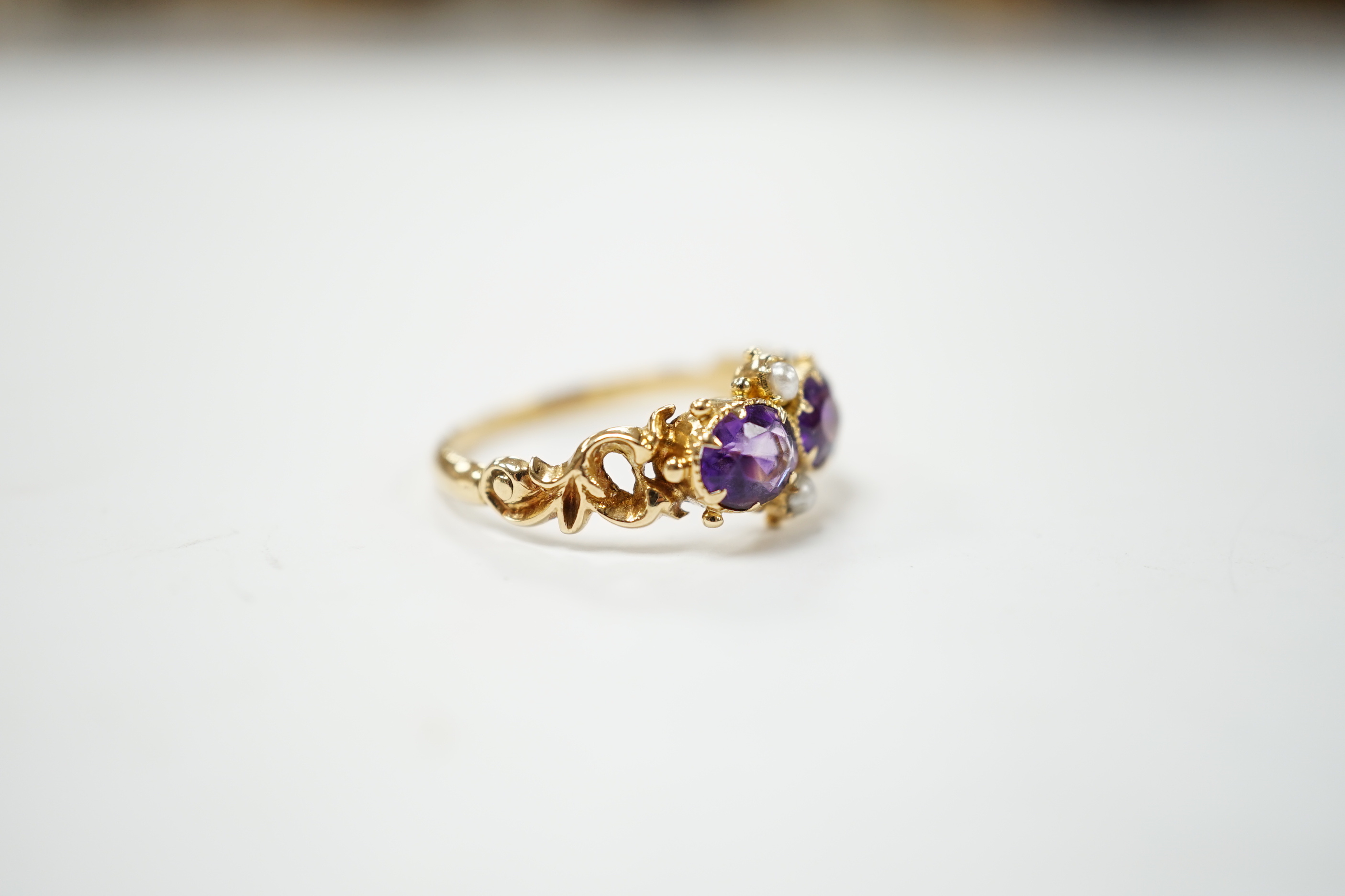 A Victorian style yellow metal, amethyst and pearl dress ring, size L